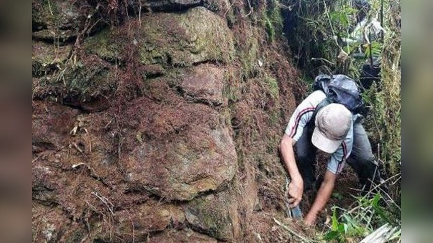 Clean-up work on one of the pyramidal site's walls